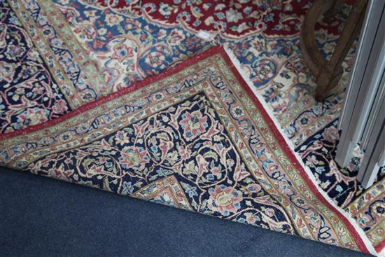 An Isfahan red and ivory ground carpet, 12ft 10in by 9ft 10in.